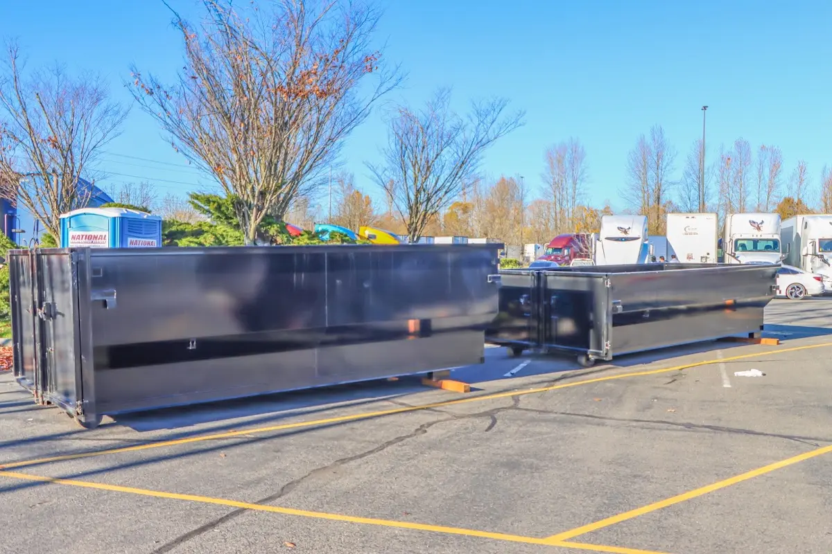 Professional dumpster rental service with roll-off container on residential driveway in Havre